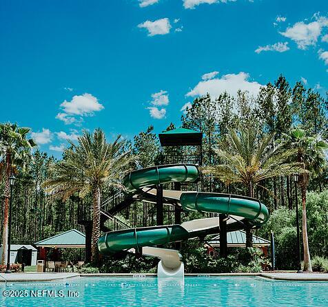 view of pool featuring a water slide