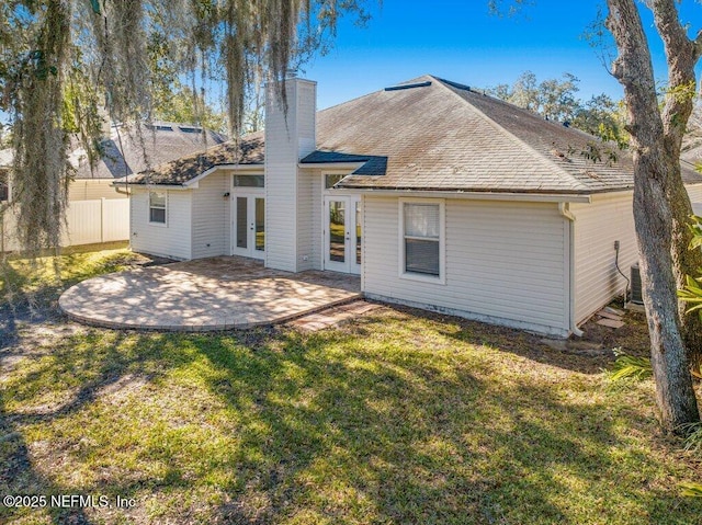 rear view of property featuring a patio area, a yard, french doors, and central AC unit