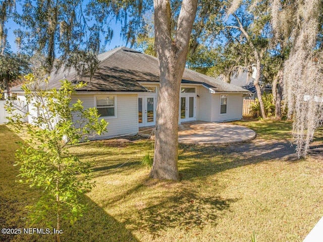 rear view of property with a patio area, a yard, and french doors