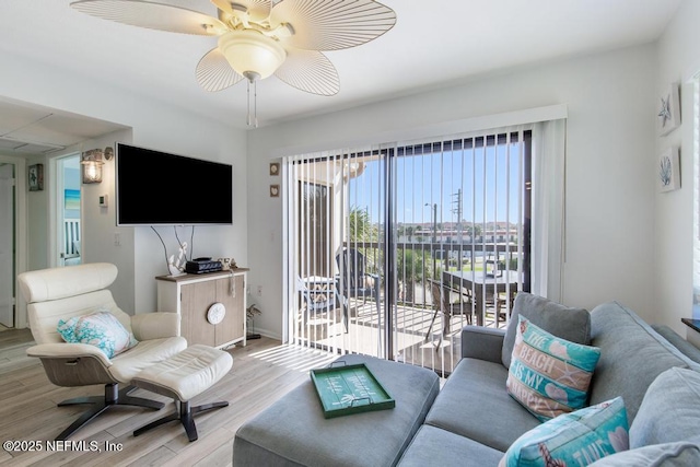 living room featuring ceiling fan and light hardwood / wood-style flooring