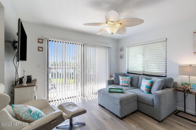 living room with ceiling fan and light hardwood / wood-style floors