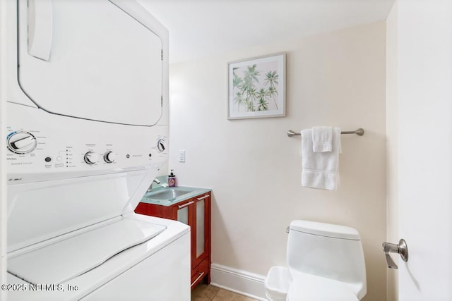 laundry area featuring stacked washer and dryer and sink