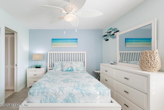 bedroom with ceiling fan, a closet, and light wood-type flooring