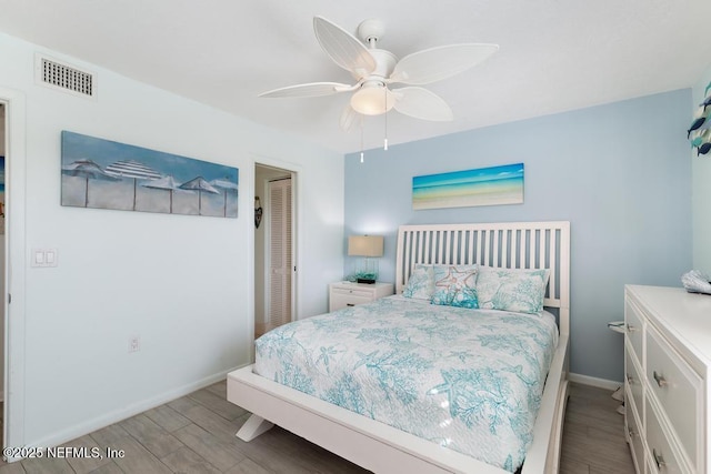 bedroom featuring a closet, light hardwood / wood-style flooring, and ceiling fan