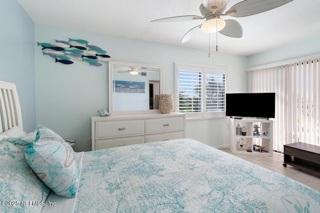 bedroom with ceiling fan and light wood-type flooring