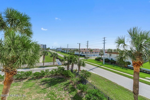 view of home's community with a yard