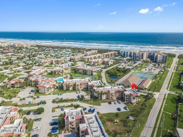 birds eye view of property with a view of the beach and a water view