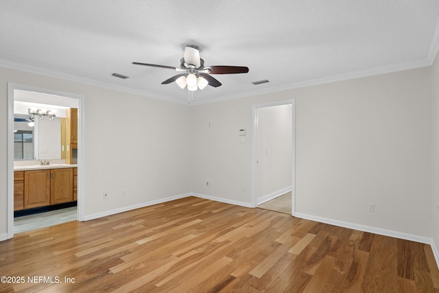 unfurnished bedroom featuring ceiling fan with notable chandelier, ornamental molding, light hardwood / wood-style flooring, and ensuite bath