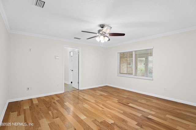 unfurnished room featuring hardwood / wood-style floors, ceiling fan, ornamental molding, and a textured ceiling