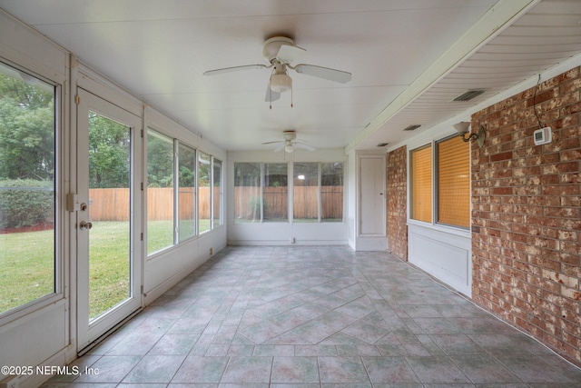 unfurnished sunroom with ceiling fan