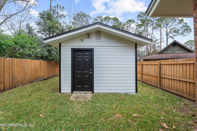 view of outbuilding featuring a lawn