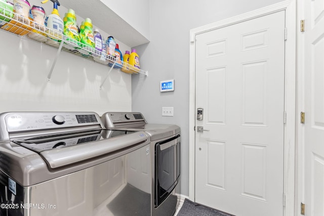 clothes washing area with washer and clothes dryer