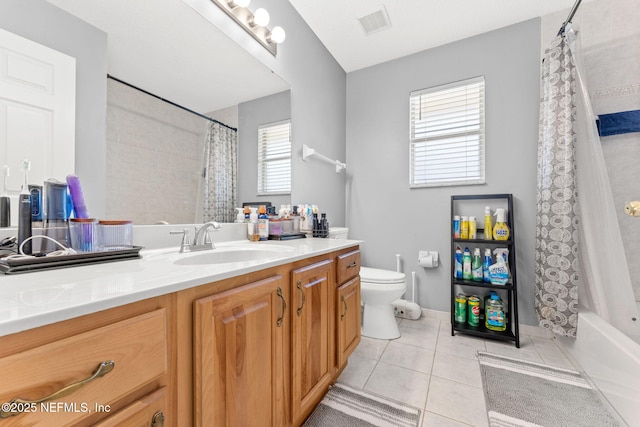 full bathroom featuring tile patterned flooring, vanity, shower / bath combo with shower curtain, and toilet