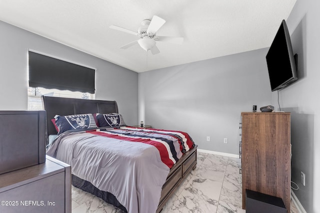 bedroom with ceiling fan and a textured ceiling