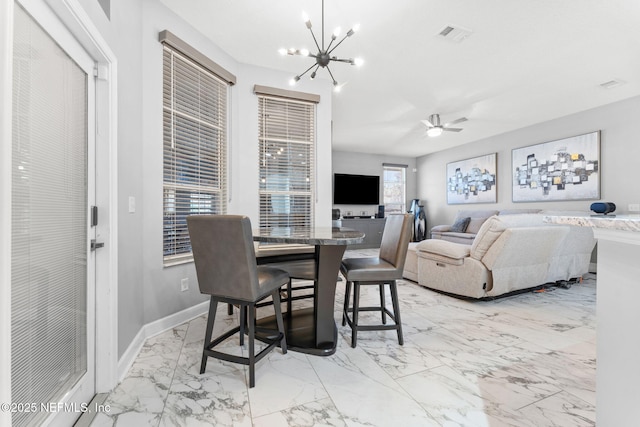 dining area with ceiling fan with notable chandelier