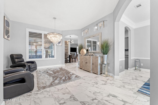 sitting room featuring ornamental molding and a chandelier