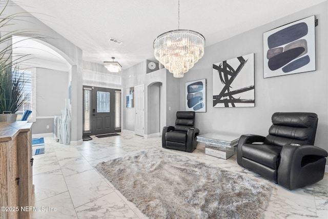 interior space with a textured ceiling and a chandelier