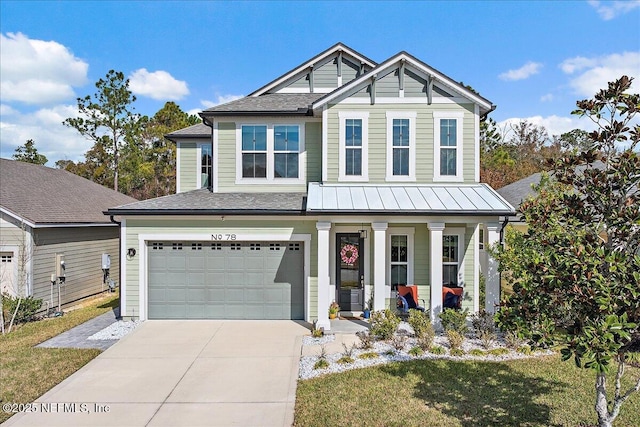 view of front facade with a garage, a front yard, and covered porch