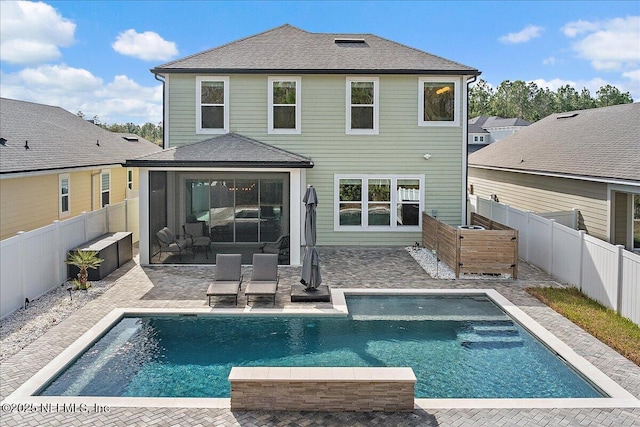 back of house featuring a fenced in pool and a patio