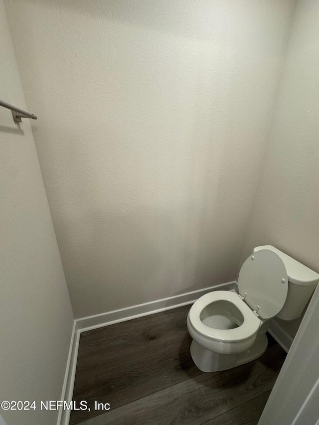 bathroom featuring hardwood / wood-style flooring and toilet