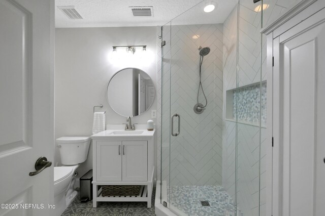 2003 Windjammer Ln, Saint Augustine, FL 32084 - bathroom featuring a textured ceiling, tile patterned flooring, a shower with shower door, toilet, and vanity