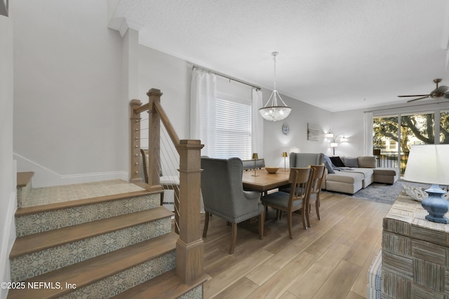 2003 Windjammer Ln, Saint Augustine, FL 32084 - dining space with ceiling fan with notable chandelier, crown molding, a textured ceiling, and light hardwood / wood-style flooring