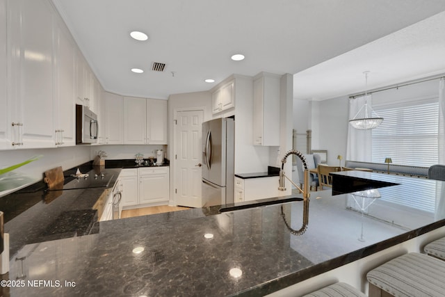 2003 Windjammer Ln, Saint Augustine, FL 32084 - kitchen with sink, white cabinetry, kitchen peninsula, and appliances with stainless steel finishes