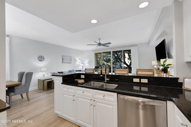 2003 Windjammer Ln, Saint Augustine, FL 32084 - kitchen featuring stainless steel dishwasher, light wood-type flooring, white cabinets, ceiling fan, and sink