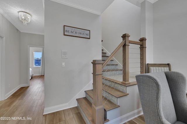 2003 Windjammer Ln, Saint Augustine, FL 32084 - stairs featuring hardwood / wood-style flooring, a textured ceiling, crown molding, and an inviting chandelier