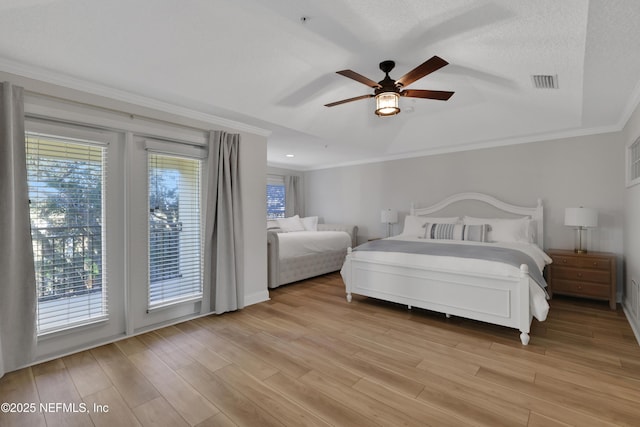 2003 Windjammer Ln, Saint Augustine, FL 32084 - bedroom featuring light hardwood / wood-style floors, crown molding, ceiling fan, access to exterior, and a textured ceiling