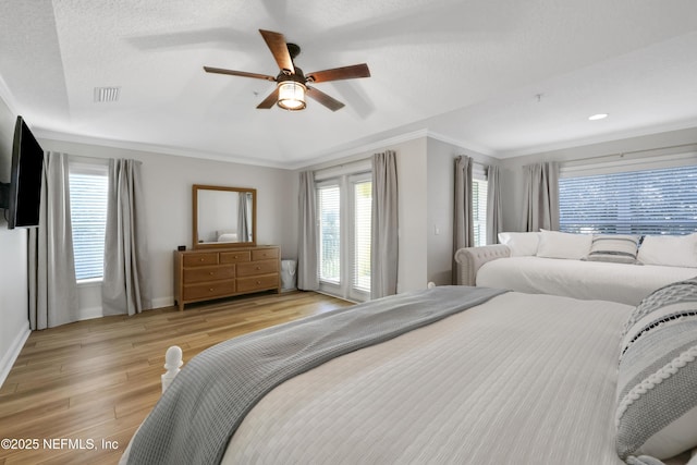 2003 Windjammer Ln, Saint Augustine, FL 32084 - bedroom with a textured ceiling, ceiling fan, crown molding, and light hardwood / wood-style floors