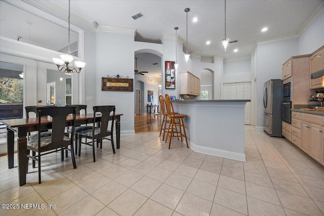 kitchen with decorative light fixtures, light tile patterned flooring, and oven