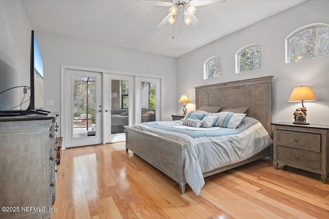 bedroom featuring ceiling fan, light hardwood / wood-style flooring, and access to outside