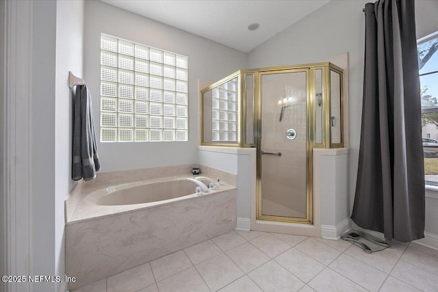 bathroom with vaulted ceiling, tile patterned flooring, and separate shower and tub