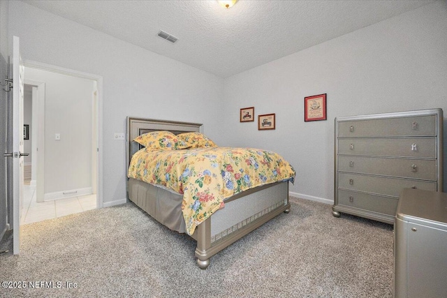 bedroom with a textured ceiling and carpet floors