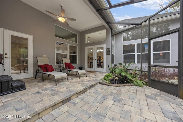 sunroom / solarium featuring ceiling fan, french doors, and vaulted ceiling