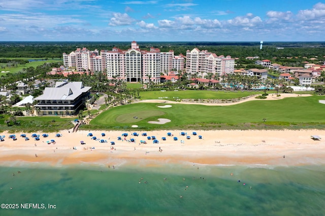 drone / aerial view featuring a beach view and a water view