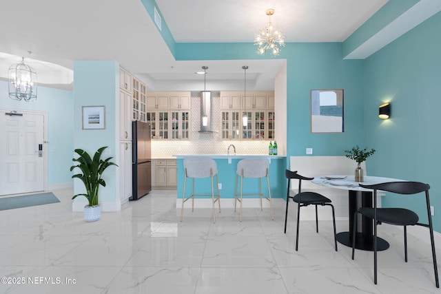 dining room with a notable chandelier and a tray ceiling