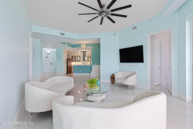 living room featuring ceiling fan with notable chandelier