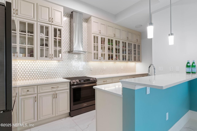 kitchen with wall chimney exhaust hood, stainless steel appliances, pendant lighting, a kitchen bar, and decorative backsplash