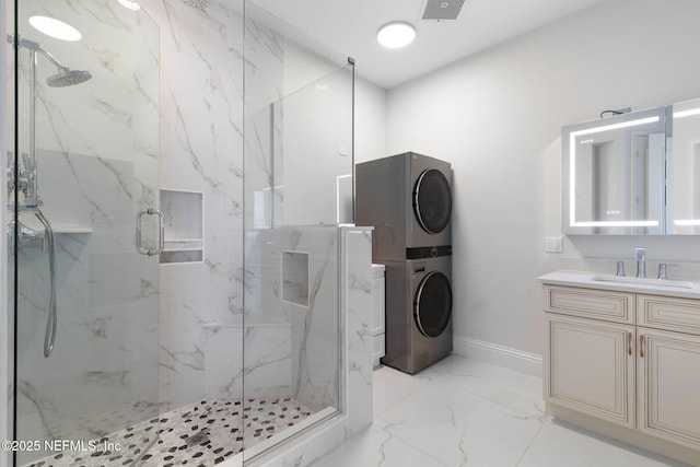 bathroom with vanity, stacked washer and clothes dryer, and walk in shower