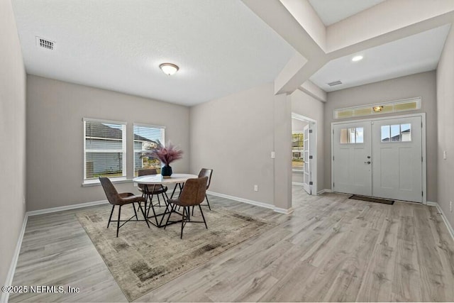 dining space featuring light wood-type flooring