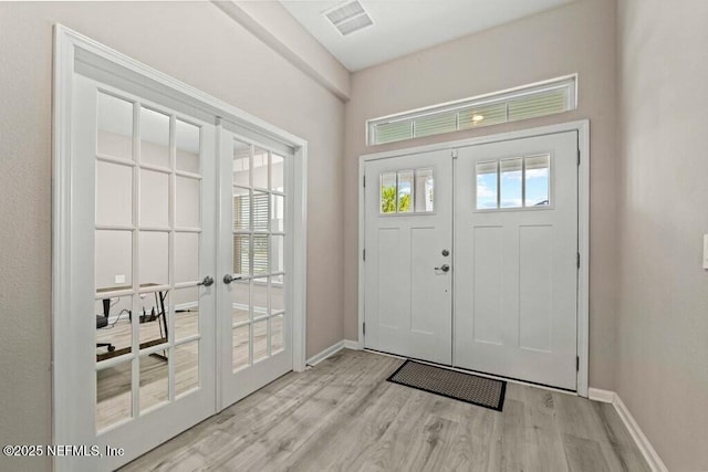 entryway with light hardwood / wood-style flooring and french doors