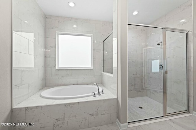 bathroom with shower with separate bathtub