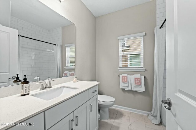 bathroom featuring toilet, vanity, and a shower with curtain