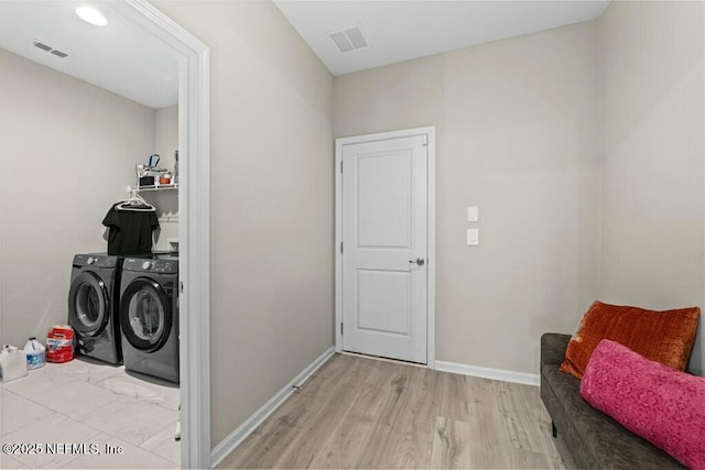 washroom featuring independent washer and dryer and light wood-type flooring