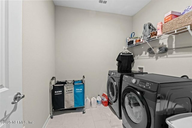 laundry room with washer and dryer