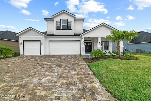 view of property with a garage and a front yard