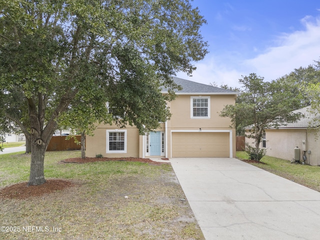 view of front of property featuring a garage and a front yard