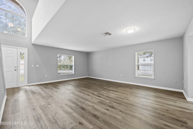 entryway with hardwood / wood-style floors and a textured ceiling